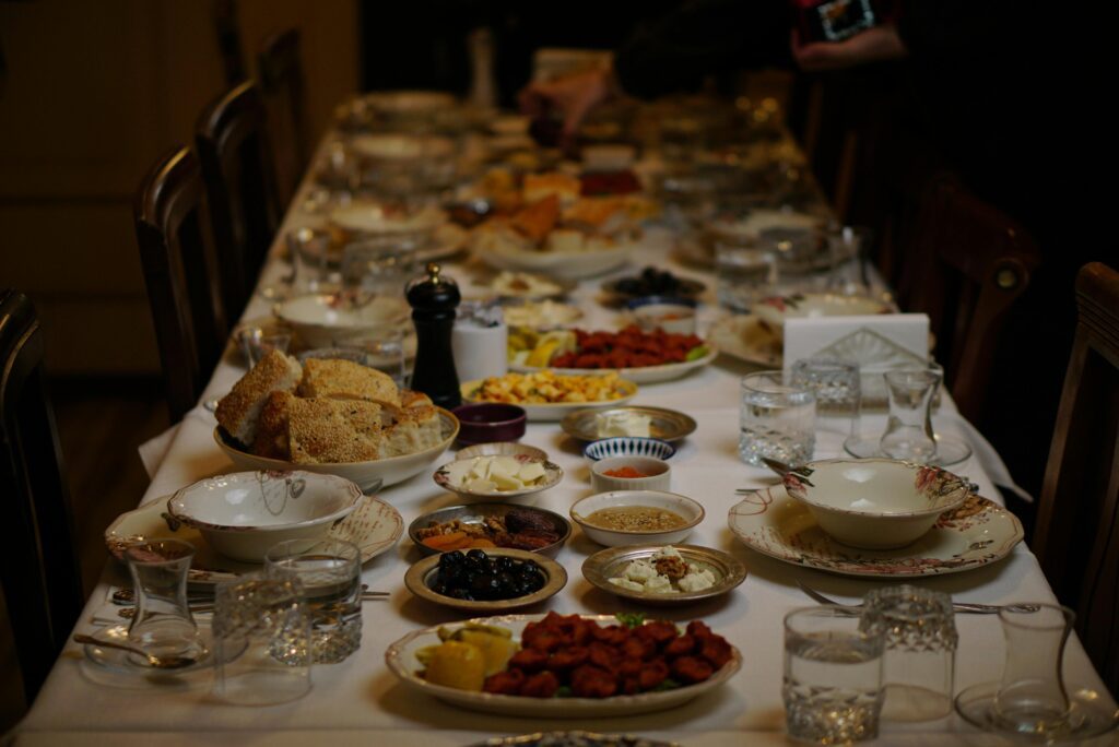 An elegantly set dinner table with various traditional and festive dishes for a gathering.