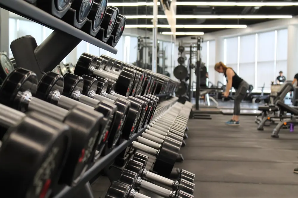 Espaço de musculação com equipamentos e pesos
